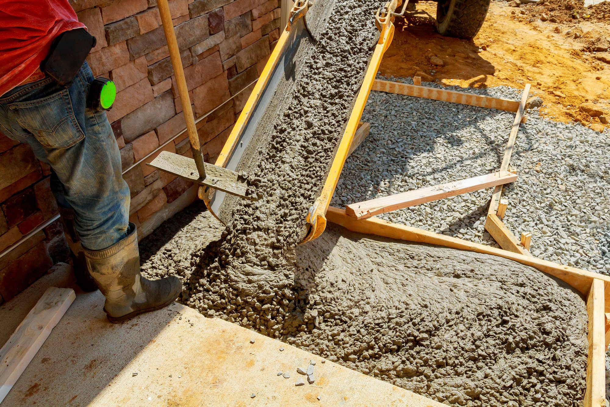 concrete is being poured into a brick wall